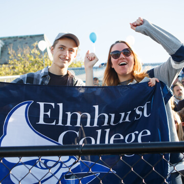 students holding up an Elmhurst College banner